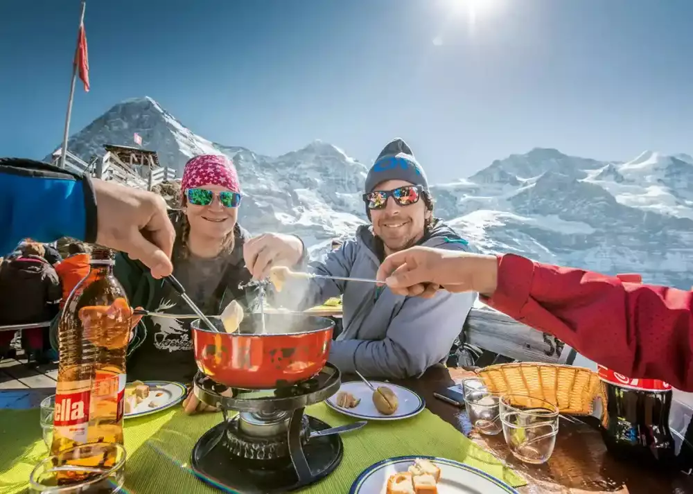 enjoying-swiss-fondue-on-the-top-of-jungfraujoch